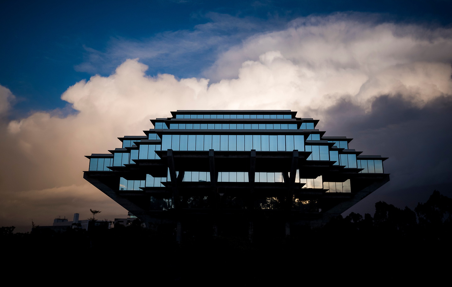 Geisel Library silhouetted against evening clouds.